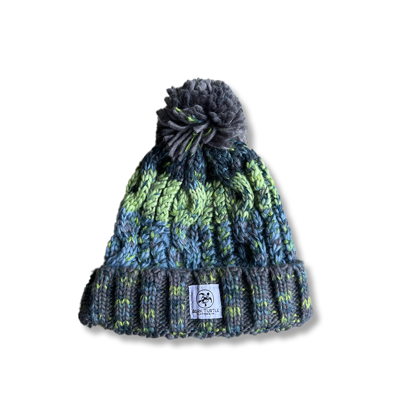 Knitted beanie with a pom-pom on a white background