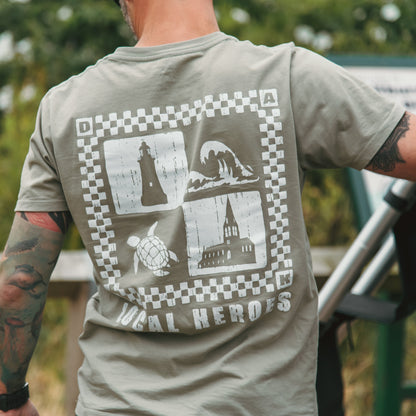 Person wearing a t-shirt with a graphic design on the back, standing outdoors.