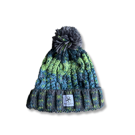 Knitted beanie with a pom-pom on a white background